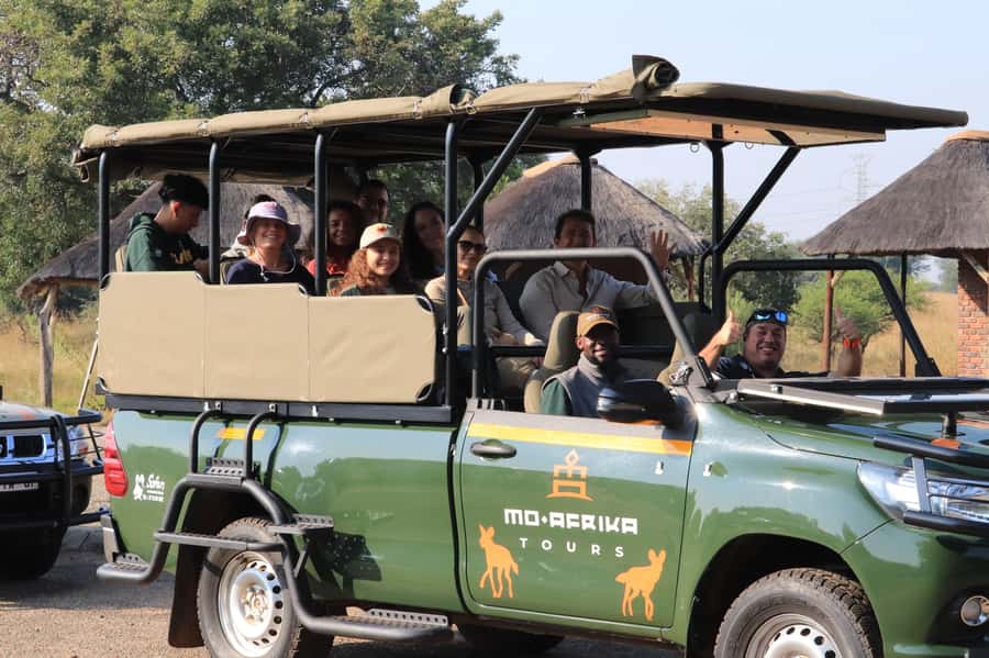 From Johannesburg: Pilanesberg Nature Reserve Game Safari - Entering Pilanesberg in an open safari vehicle