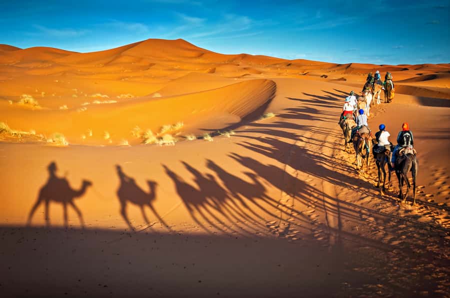 From Marrakech: 3-Day Merzouga and Sahara Desert Tour - Camel riding into the Sahara at sunset