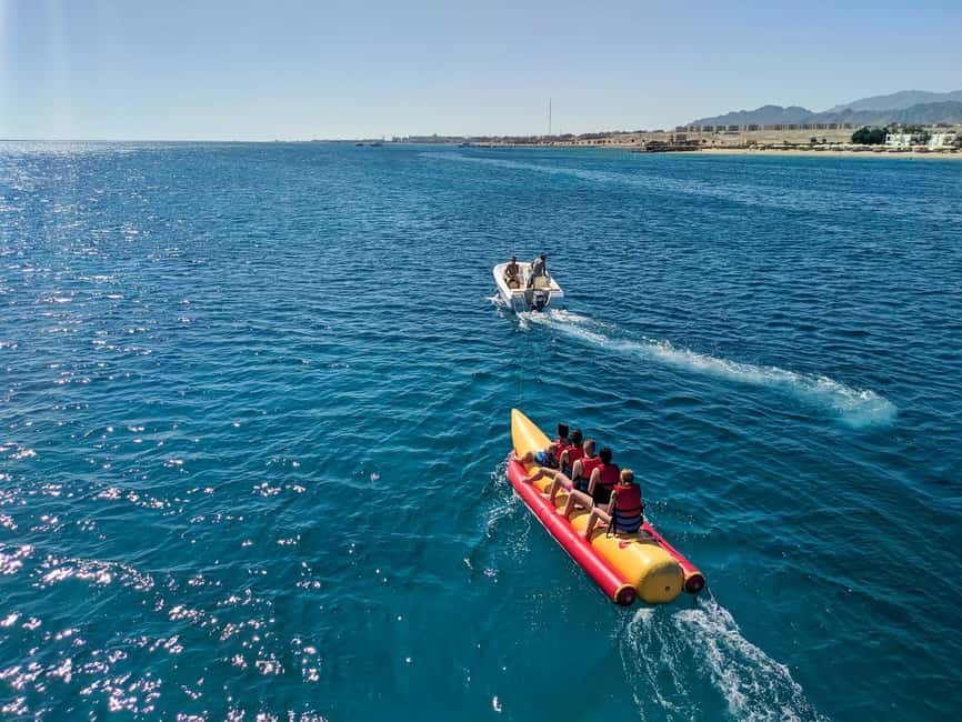 Hurghada: Orange Bay Day Trip with Water Sports and Lunch - Orange Bay, swings, and shallow turquoise water