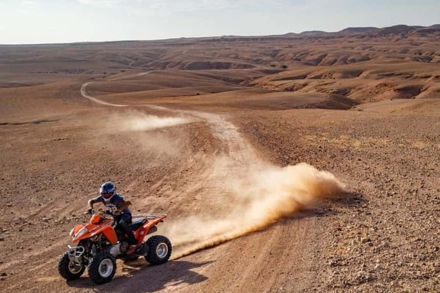 Marrakech: Agafay Desert Quad Biking Tour with Dinner-Show - Riding through Agafay with the Atlas Mountains behind you