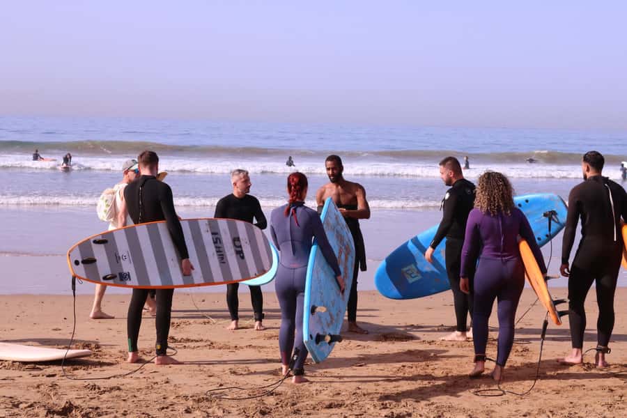 Surf Lessons with Local instructor - Carrying the board to Taghazout’s waves